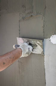 stucco getting applied by contractor on residential home