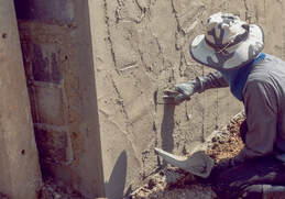 stucco contractor working on the exterior walls